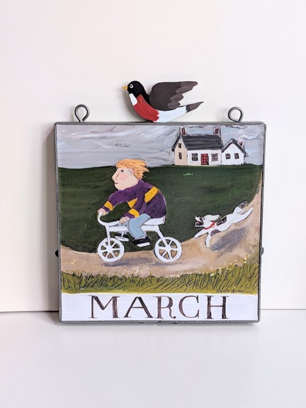 Nancy Thomas Wall Plaque 8" Metal Framed "March" Boy Riding Bicycle 2003 Folk Ar